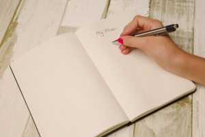 A woman's hand writing a list